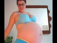 Mature pregnant woman looking hot on her blue cute outfit 